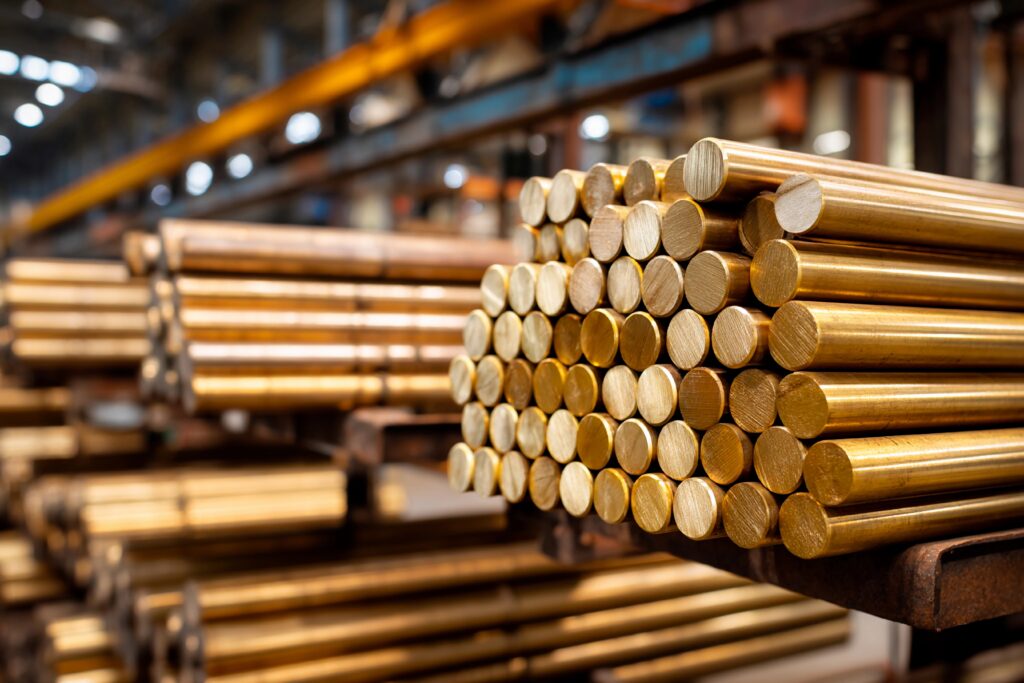 workers are focused on assembling brass rods in a bustling manufacturing facility. the rods are stacked neatly, showcasing the shiny metal surfaces in excellent condition