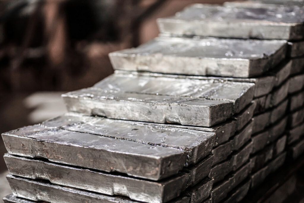 close up of a pile of zinc ingots. raw materials for the smelting industry. aluminum, tin, iron. rough metal bricks.